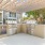 Outdoor grilling station with stainless steel gas grills and shaded pergola beside the pool at Baton Rouge apartments.