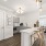 Clubhouse kitchen with bar seating, coffee station, and modern lighting for residents in Baton Rouge apartments.