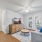 Bright living space with natural light, modern decor, and access to private patio through French doors.