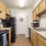 Galley kitchen with black appliances, wood cabinets, and laminate countertops in Baton Rouge apartment.