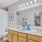 Spacious bathroom with dual-sink vanity, framed mirror, and bright lighting in East Baton Rouge apartment.