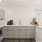 Resident coffee bar and snack area with gray cabinetry, marble countertops, and wood flooring at Baton Rouge apartments.