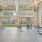 Modern fitness center with cardio and strength training equipment overlooking landscaped courtyard in Baton Rouge apartments.