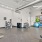 Apartment fitness studio with dumbbells, resistance bands, and large windows offering views of the Baton Rouge community.