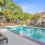 Outdoor Pool on Sundeck with lounge chairs within apartment community