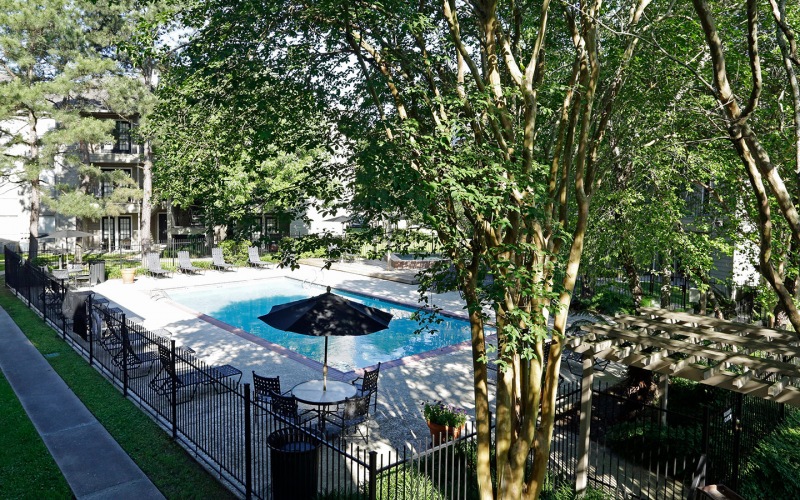 Large shaded pool area with large pool deck 